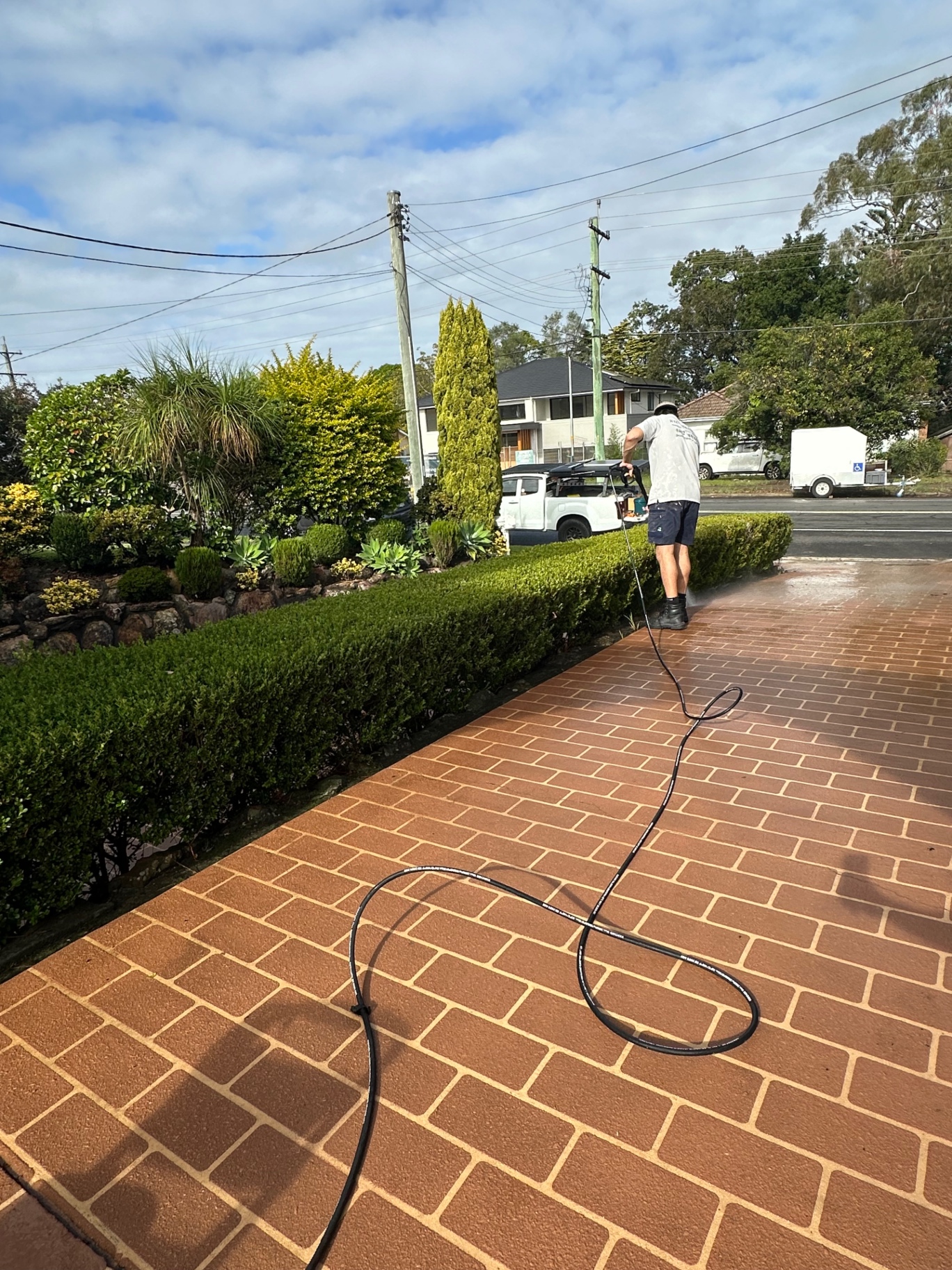 JJ Exterior Cleaning pressure washing a brick driveway in Sydney's Hills District